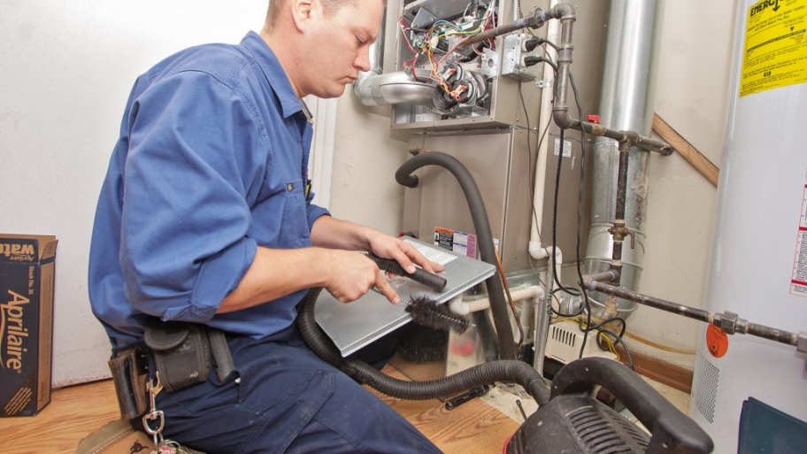 HVAC technician inspecting