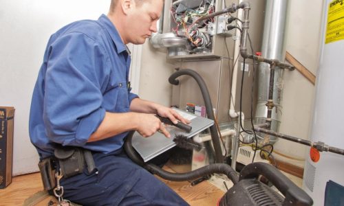 HVAC technician inspecting